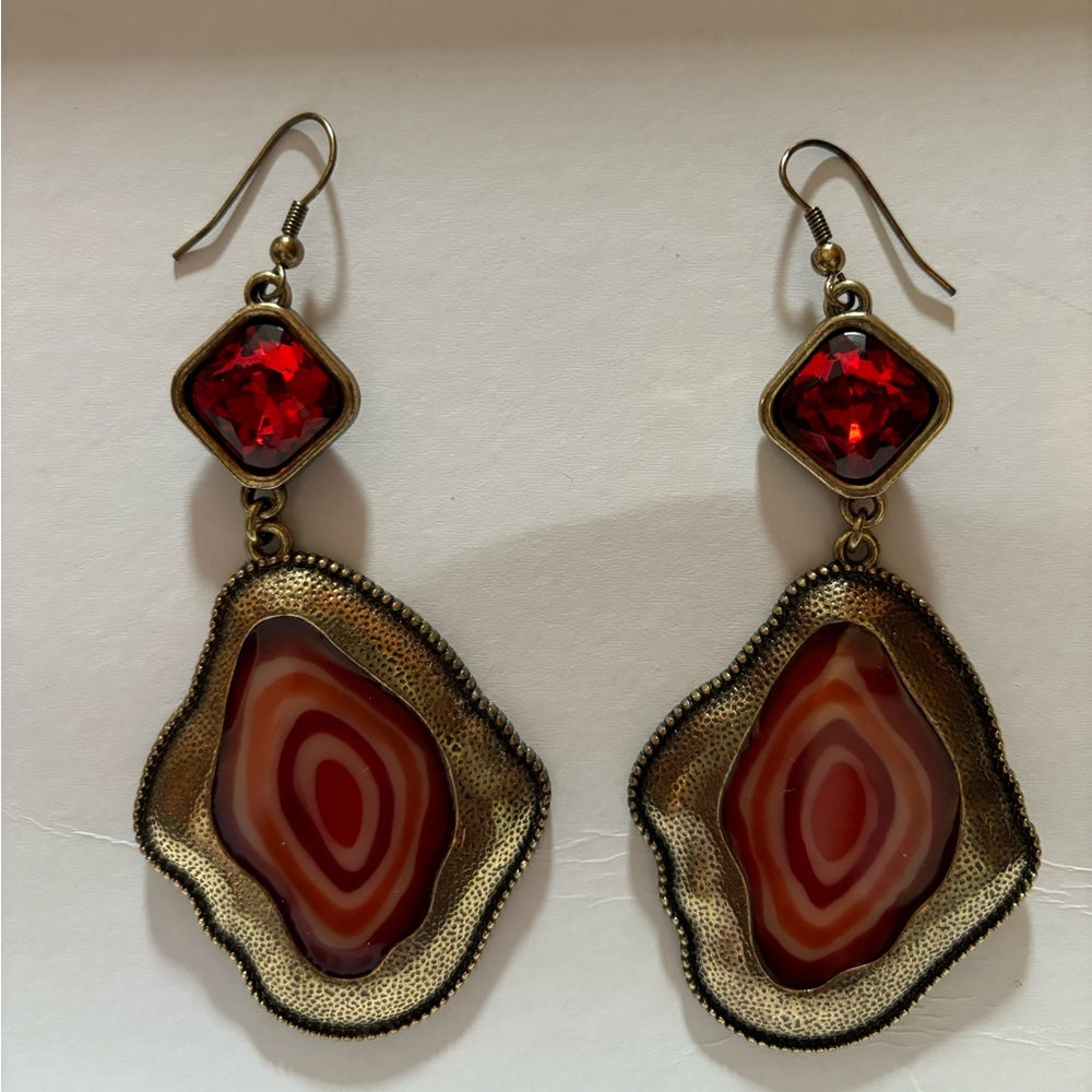 Gold tone earrings with red stones